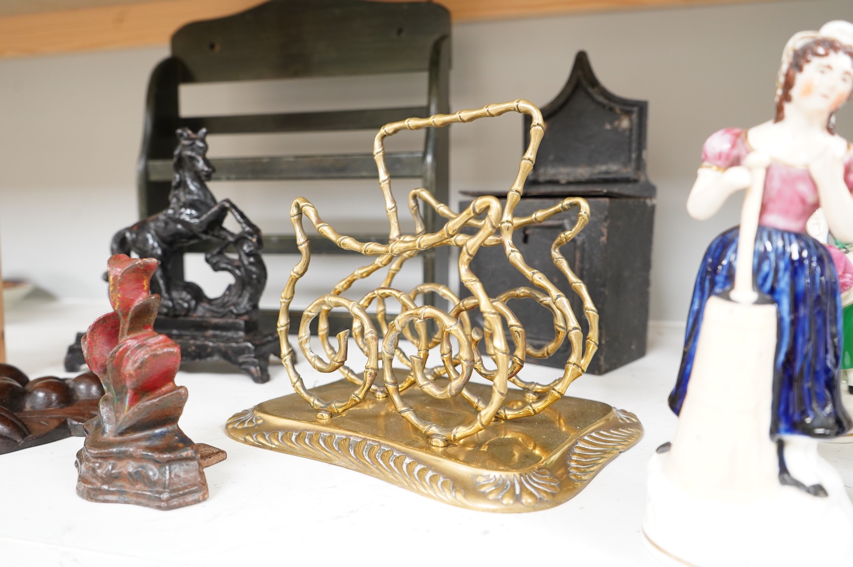 Sundry items to include an iron money box, brass letter rack, horse door stop and a 19th century oak carving, largest 32cm high